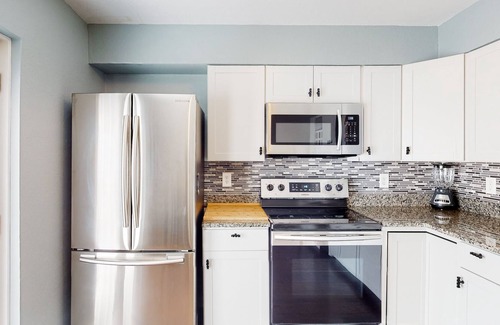 Bayview House | Water view home with five bedrooms, enclosed yard, gas grill, central AC, & W/D