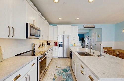 Sunset Island Condo | 4-story townhome with resort pools, beaches, water access, & great location