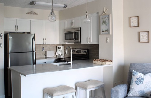 North Ocean City Condo | Hidden Harbor - canal front 1st floor condo with balcony, shared pool, next to Northside Park.