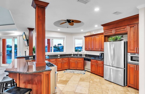 Causeway Isles House | Indulge in luxury at this expansive three-story waterfront retreat.
