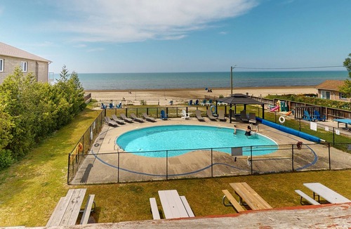 Wasaga Beach House | Lakefront condo steps to the beach with pool, and fireplace