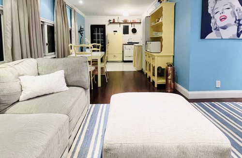 Baldwin Harbor Apartment | Poolside play with a relaxing hot tub, fire pit, & gazebo with a television.