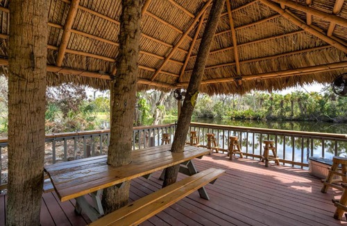 Braden River Apartment | Riverside Breeze Tropical Retreat w Tiki Hut&BBQ