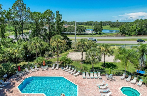 Royal Palm Bay Condo | Sunflower-yellow condo with pool, W/D, hot tub & kitchen - dog/snowbird-friendly