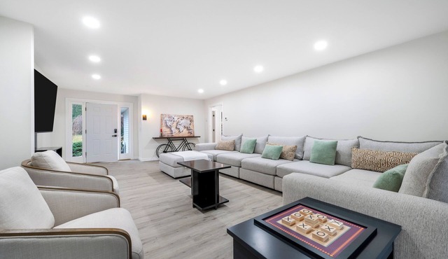 Features two living rooms, sauna, hot tub, and fire pit -over 4 acres of land.