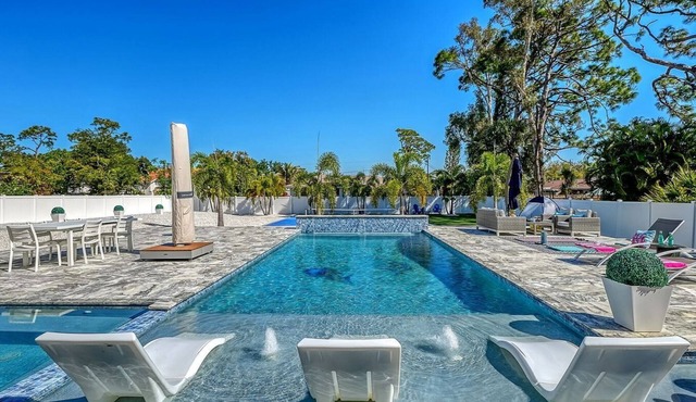 Modern luxury retreat near Siesta Key with a heated saltwater pool, hot tub, private sports court, and cinema room. Fully furnished designer home with indoor-outdoor living, perfect for relaxing, entertaining, and enjoying the best of Sarasota.