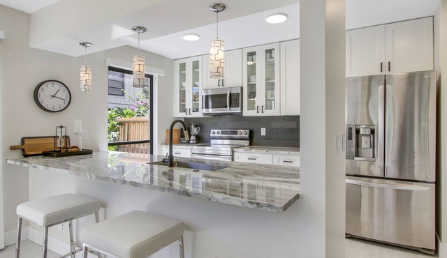 Serene Water-View Retreat with Wraparound Lanai & Elegant Renovations