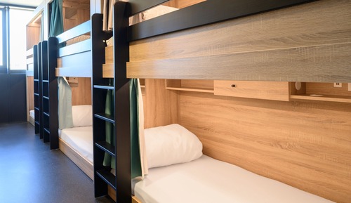 Bed in dormitory of 8 with shared bathroom